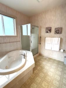 基洛纳Serenity Valley Homestead of Kelowna的大型浴室设有浴缸和淋浴。