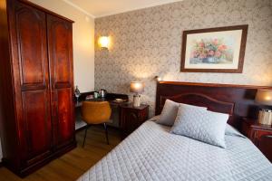 派尔努传奇酒店的一间卧室配有一张床和一张桌子及椅子