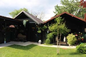 森克Frenk cottage 5 KM FROM THE AIRPORT possible drive to the airport and back payment的一座房子,有小树的院子