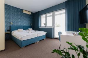 尼特拉Penzion Tofi的蓝色的卧室设有床和窗户