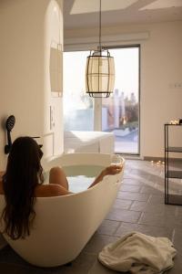 阿德里安诺斯坎波斯Thalasses的坐在一个房间里浴缸里的女人