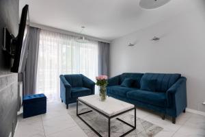 米兹多洛杰梅蒂多杰公寓的客厅配有蓝色的沙发和桌子