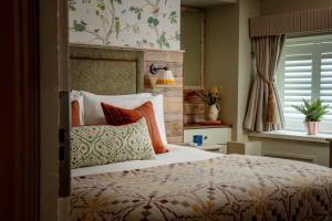 塞特尔塞特尔金狮l旅馆的一间卧室配有一张带色彩缤纷枕头的大床
