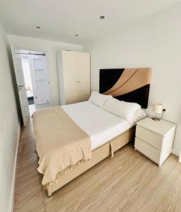 桑坦德Dávila HOME Beach的一间卧室配有一张大床和一个床头柜