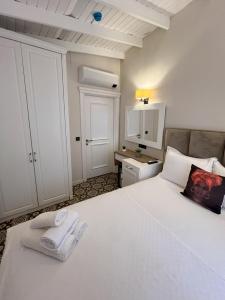 阿拉恰特Alaçatı Disa的卧室配有带毛巾的大型白色床