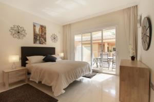 马贝拉Aloha Hill Club LLuxury 5 Star Golf Resort Near Puerto Banus and Marbella的一间卧室设有一张床和一个阳台