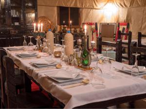 梅尔祖卡Services Luxury Camp的一张桌子上放着白色的桌布和蜡烛