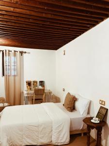 得土安Tarbi'aat Tetaoun 44, 17th century heritage的卧室设有白色的床和木制天花板。