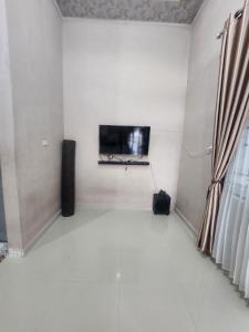 HalanganHomeStay Pandan Baru的客厅设有壁挂式平面电视。