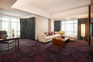 河内河内铂尔曼酒店的客厅配有沙发和桌子