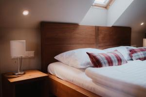 圣马丁安德达斯艾森伯格酒店的一间卧室配有一张带木制床头板和枕头的床。
