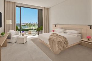 吉达The Jeddah EDITION的一间白色的卧室,配有床和客厅