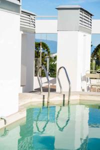 卡塔马卡HOTEL ARENALES的一个带两把金属椅子的游泳池
