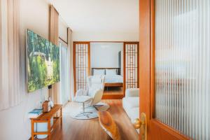 西归浦市Dazayo Hacheon Breeze House Pakeori - Pet friendely的一间带白色椅子的客厅和一间卧室