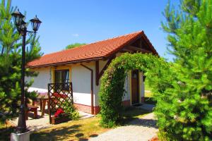 利普托斯基米库拉斯Chata u vinára Milana, Tatralandia的一间白色的小房子,有红色的屋顶