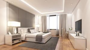 阿尔弗斯顿Lonsdale House Luxury Apartments的卧室配有白色的床和电视。