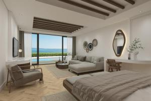 凯里尼亚Acapulco Resort Hotel的一间带大床的卧室和一间客厅