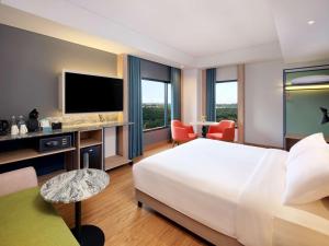当格浪ibis Styles Serpong BSD City的酒店客房设有一张大床和一台电视。