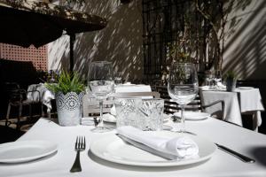 圣马丁德巴尔代格莱西亚斯拉克拉赛拉庄园酒店的一张桌子,上面有白板和酒杯