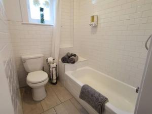 魁北克市Old Quebec - Les Suites Montcalm #2 - Free Parking的白色的浴室设有卫生间和浴缸。