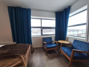 伊温斯科尔帖尔德孙布鲁瓦酒店的一间卧室配有一张床、两把椅子和窗户