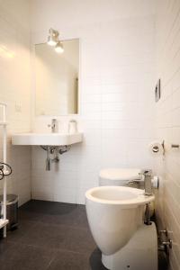 卡利亚里卡利亚里I'MC IoAMo旅馆的一间带卫生间、水槽和镜子的浴室