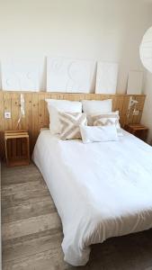 La Chapelle-EnchérieMaison ecologique en paille的一张白色大床,配有白色床单和枕头