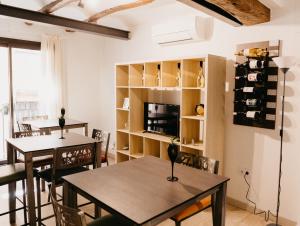 MasroigCamins del Priorat Ermita sant Pau的一间带两张桌子和电视的用餐室