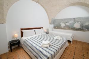 奥斯图尼Borgo Santuri的一间卧室配有带毛巾的床