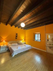 ZubietaZubietako Ostatua的一间设有黄色墙壁和一张大床的大卧室