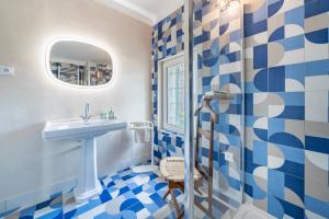瓦洛里Domaine des Encourdoules的蓝色和白色的浴室设有水槽和淋浴