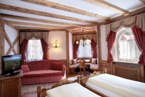 圣马蒂诺-迪卡斯特罗扎考尔布利恩美容加放松酒店的一间带沙发、椅子和电视的卧室