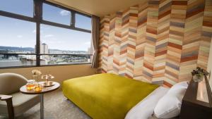 柳川柳川新盖亚经济型酒店的一间卧室设有黄色的床和窗户。