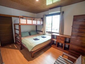 LagudriJamburae Lodge的一间卧室配有两张双层床和一张书桌