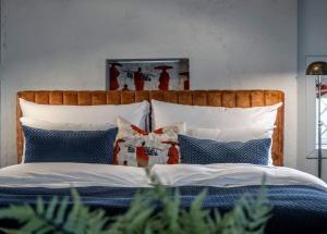 卑尔根Vertshuset Konow的一张带木制床头板和枕头的床