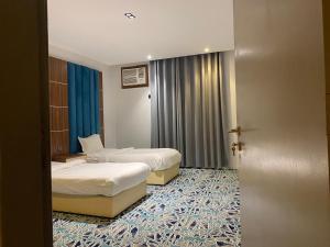 艾卜哈كيان ألين的一间酒店客房,设有两张床和门廊