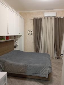 丽都迪奥斯蒂亚Appartamento 50 mt dal mare的一间卧室配有一张床和白色橱柜
