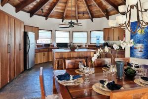 圣佩德罗Villa Serenity的厨房配有木桌和冰箱。