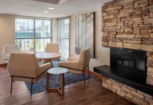 沃灵福德Fairfield by Marriott Inn & Suites Wallingford New Haven的一间设有椅子和壁炉的等候室