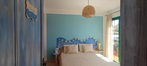 亚伊萨Casa Luz的一间卧室配有一张蓝色墙壁的床