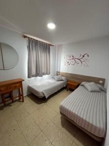 波多黎各布埃纳维斯塔公寓酒店的一间卧室配有两张床和镜子