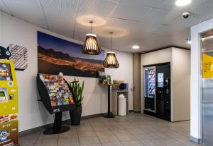 格勒诺布尔B&B HOTEL Grenoble Centre Verlaine的一间设有苏打水机和自动售货机的等候室