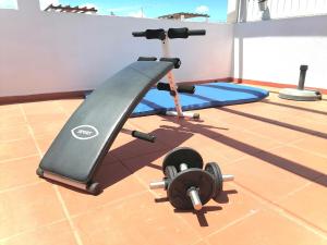 拉戈斯Marreiro's house Algarve - Child friendy - Private Pool的地面上设有跑步机和举重器材的健身房
