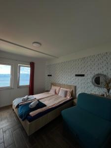 斯特鲁加Vila Vista Magica Radozda的一间卧室配有一张床和一张蓝色的沙发