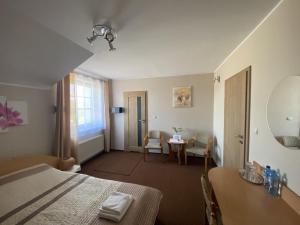 皮拉Motel Orion的酒店客房带一张床、一张桌子和椅子