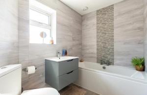 切森特Whiteclouds的浴室配有卫生间、盥洗盆和浴缸。