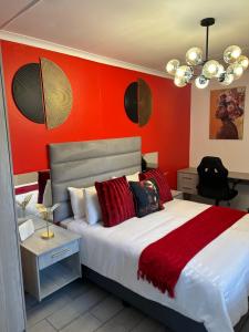 布隆方丹SiBella guest house的一间卧室设有一张带红色墙壁的大床