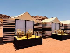 瓦迪拉姆Desert Bedouin adventure的沙漠中一群带椅子的帐篷