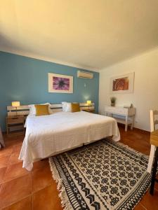 拉戈斯Vila Graciosa - Tranquility Oasis的一间卧室设有一张大床和蓝色的墙壁