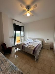 MutignanoLa Foresteria- Azienda agricola Garra的一间卧室配有一张床和吊扇
